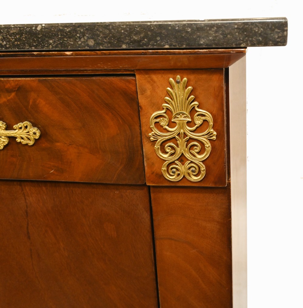 A late 19th-century French Empire mahogany escritoire desk featuring a dark marble top, drop-front writing compartment, three lower drawers, and ornamental gilt-bronze mounts. View VII