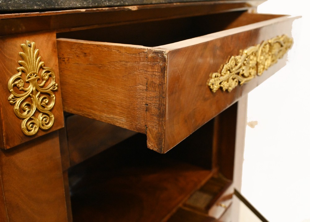 A late 19th-century French Empire mahogany escritoire desk featuring a dark marble top, drop-front writing compartment, three lower drawers, and ornamental gilt-bronze mounts. View XIV