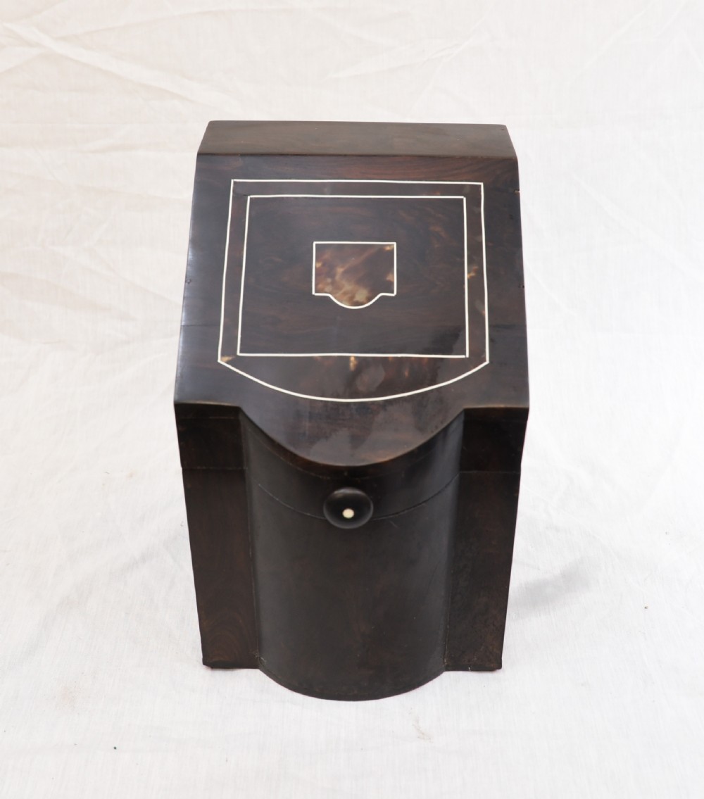 An antique dark brown coromandel wood cutlery box featuring a sloped lid with bone stringing inlay and a circular knob handle.