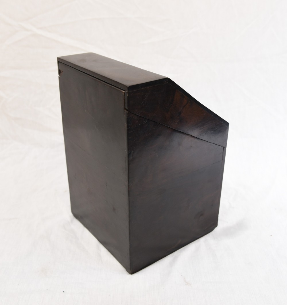An antique dark brown coromandel wood cutlery box featuring a sloped lid with bone stringing inlay and a circular knob handle. View IV