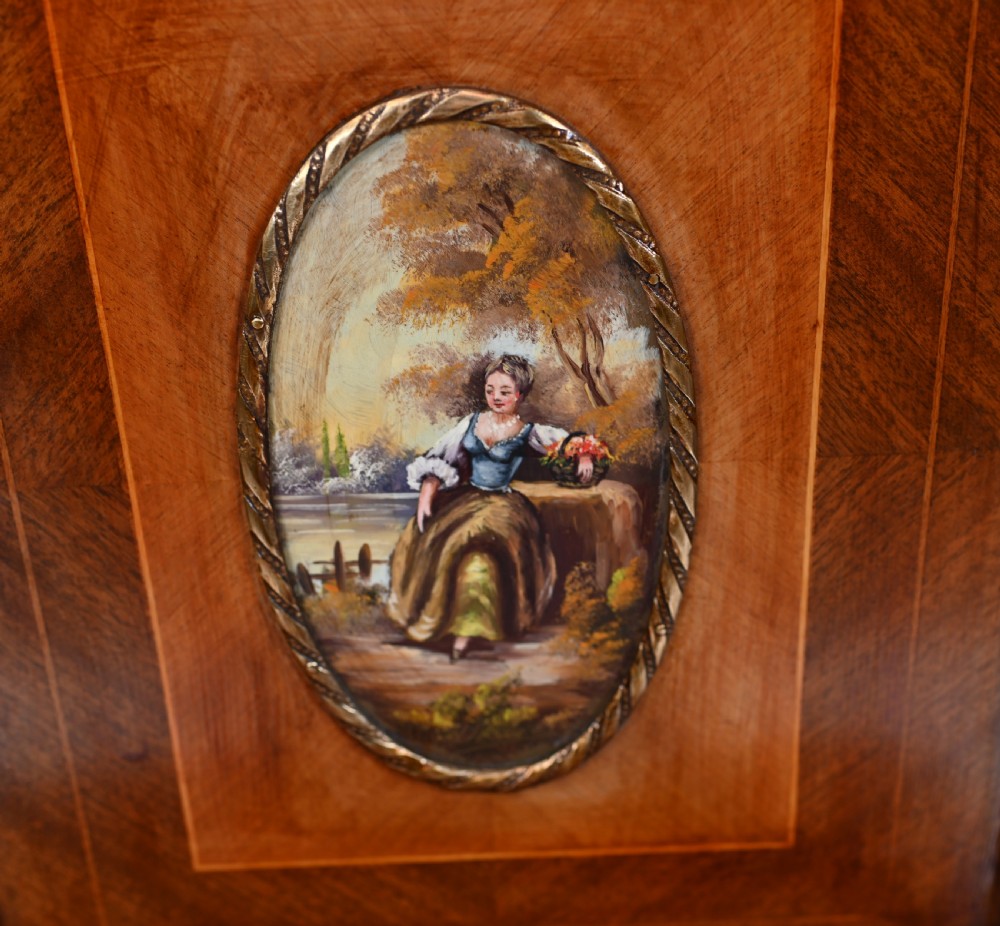 A French Louis XV style kingwood bonheur de jour desk featuring two upper cabinet doors inset with oval painted porcelain plaques, ornate metal mounts, and cabriole legs. View IV