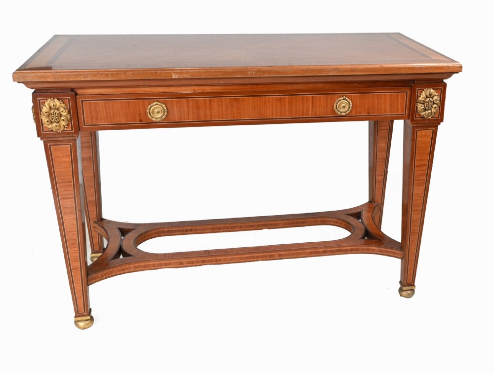 A pair of French Empire style mahogany console tables featuring satinwood crossbanding, gilt-bronze rosette mounts, and curved lower stretchers. View II