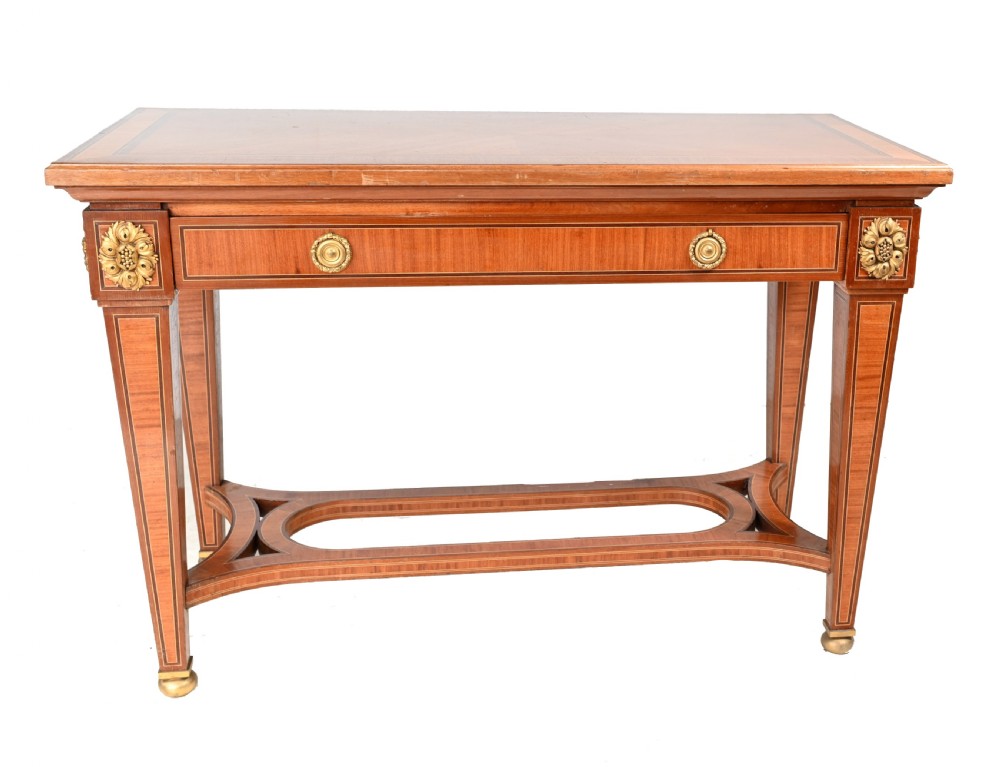 A pair of French Empire style mahogany console tables featuring satinwood crossbanding, gilt-bronze rosette mounts, and curved lower stretchers. View III