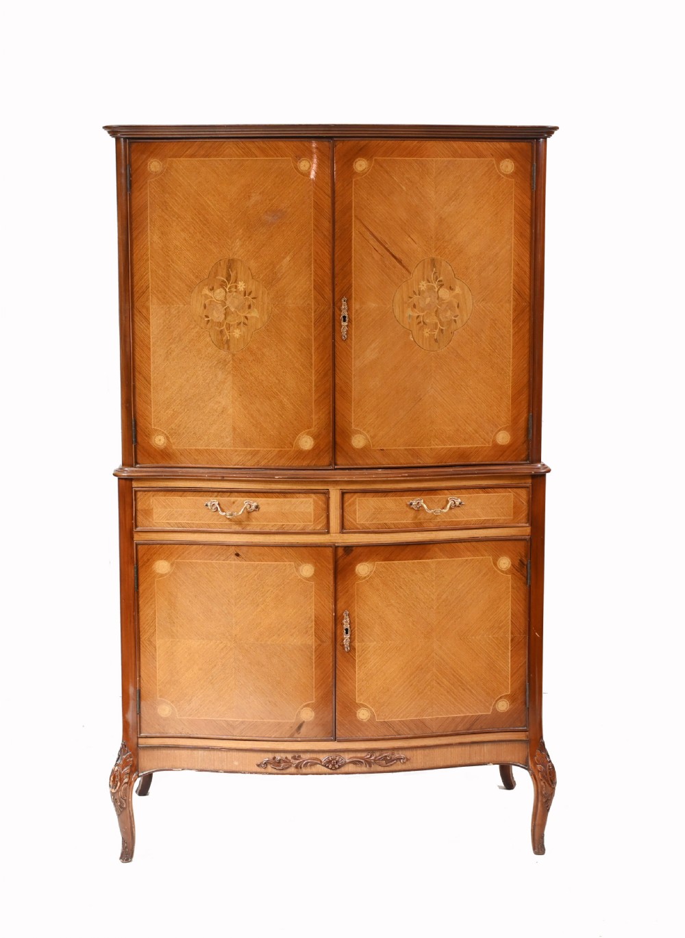 An Art Deco walnut drinks cabinet featuring floral marquetry panel doors, two central drawers, and carved cabriole legs.