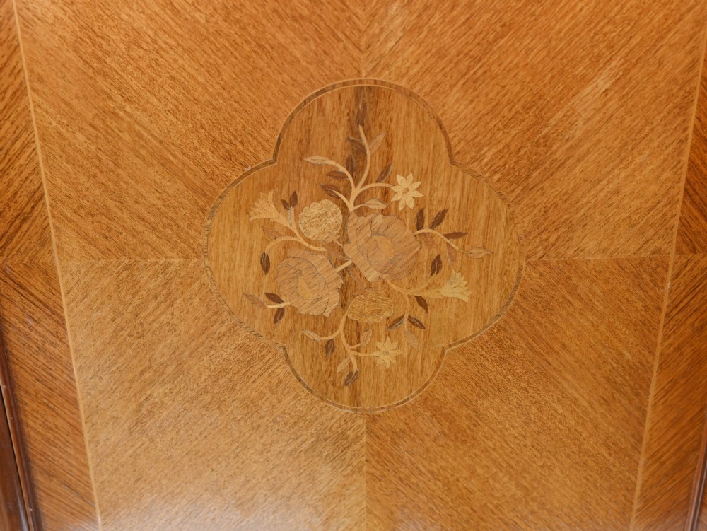 An Art Deco walnut drinks cabinet featuring floral marquetry panel doors, two central drawers, and carved cabriole legs. View III