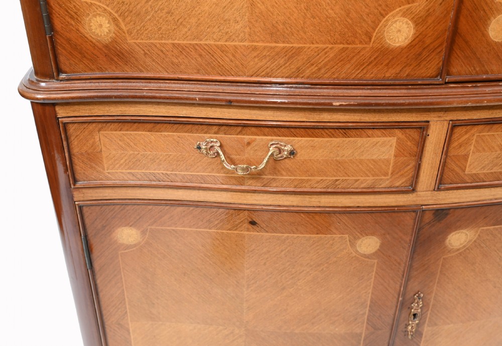 An Art Deco walnut drinks cabinet featuring floral marquetry panel doors, two central drawers, and carved cabriole legs. View IV