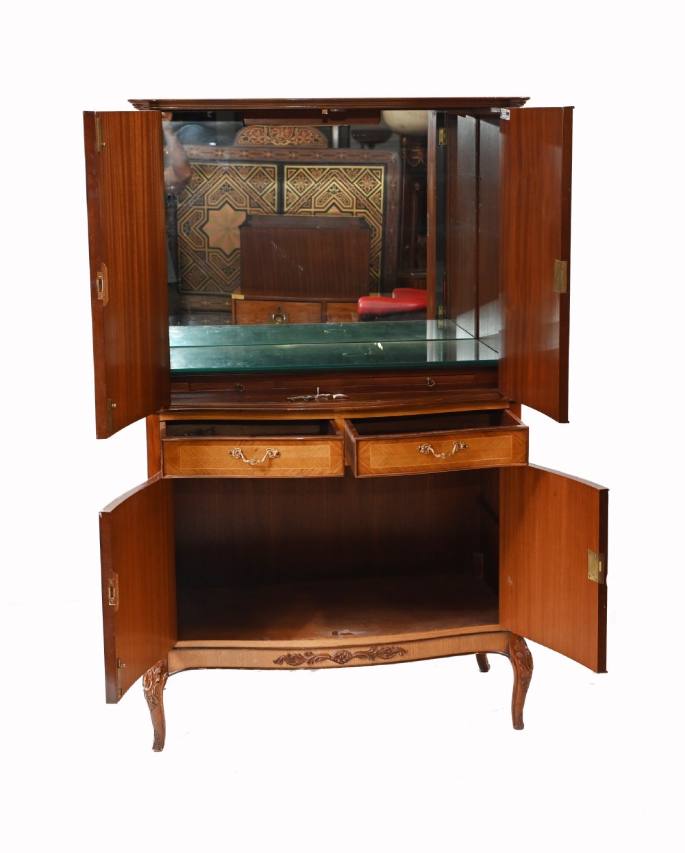 An Art Deco walnut drinks cabinet featuring floral marquetry panel doors, two central drawers, and carved cabriole legs. View VI