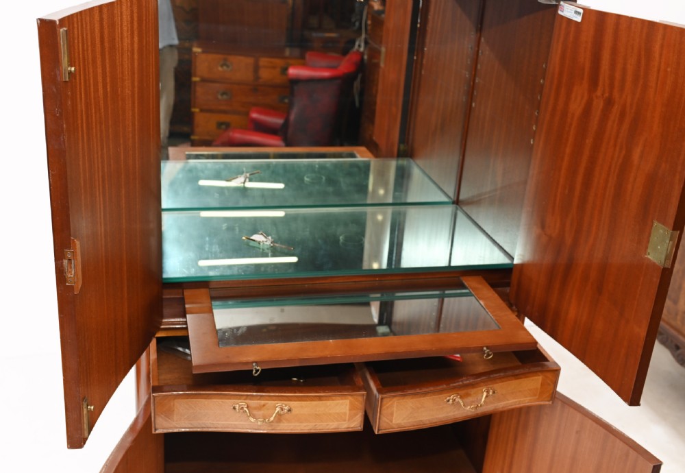 An Art Deco walnut drinks cabinet featuring floral marquetry panel doors, two central drawers, and carved cabriole legs. View VII