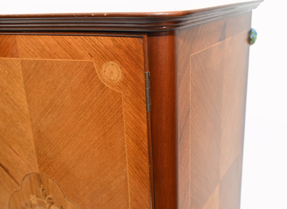 An Art Deco walnut drinks cabinet featuring floral marquetry panel doors, two central drawers, and carved cabriole legs. View VIII