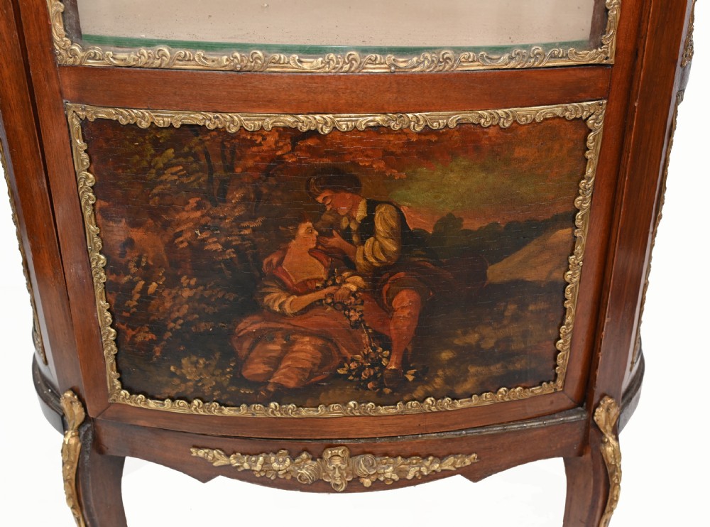 A French Vernis Martin style mahogany display cabinet featuring curved glass panels, gilt-bronze mounts, and a hand-painted pastoral scene on the lower door. View II