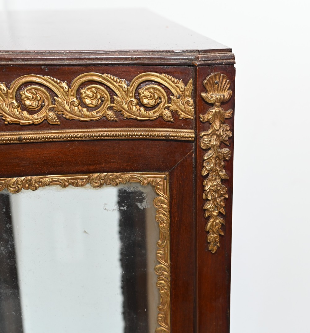A French Vernis Martin style mahogany display cabinet featuring curved glass panels, gilt-bronze mounts, and a hand-painted pastoral scene on the lower door. View VIII