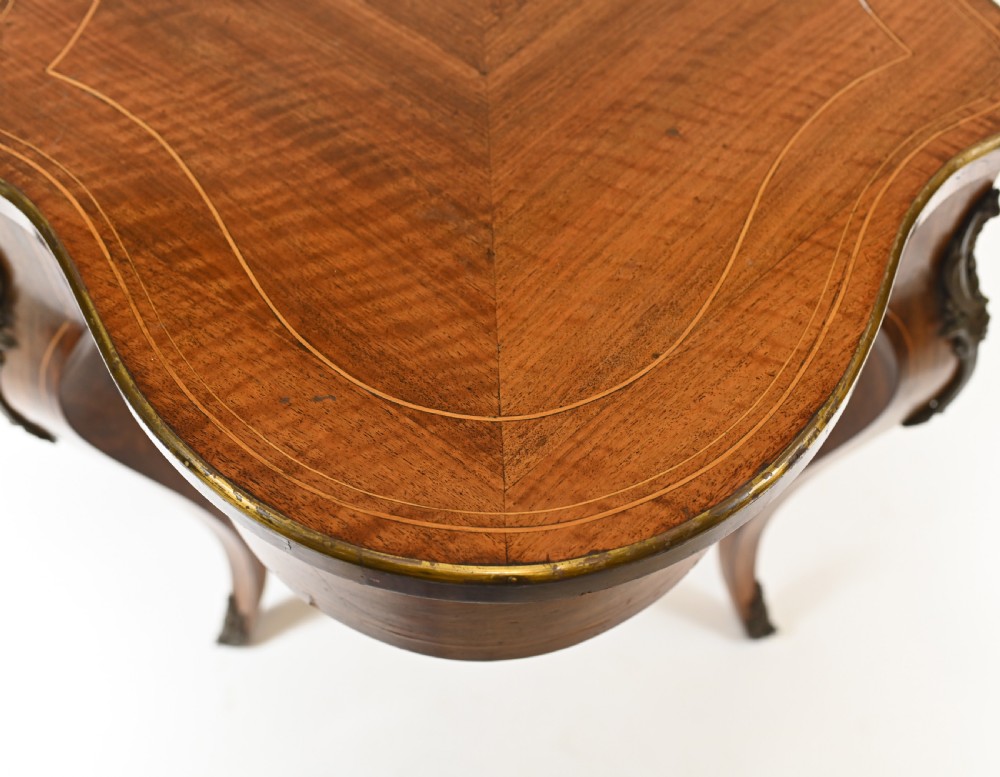 A French Louis XV style centre table featuring a serpentine top with floral marquetry inlay, slender cabriole legs, and metal mounts. View IX