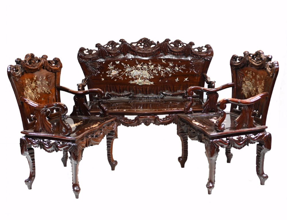 A three-piece dark hardwood seating suite comprising a double bench and two armchairs, decorated with mother of pearl floral inlays and carved detailing. View II