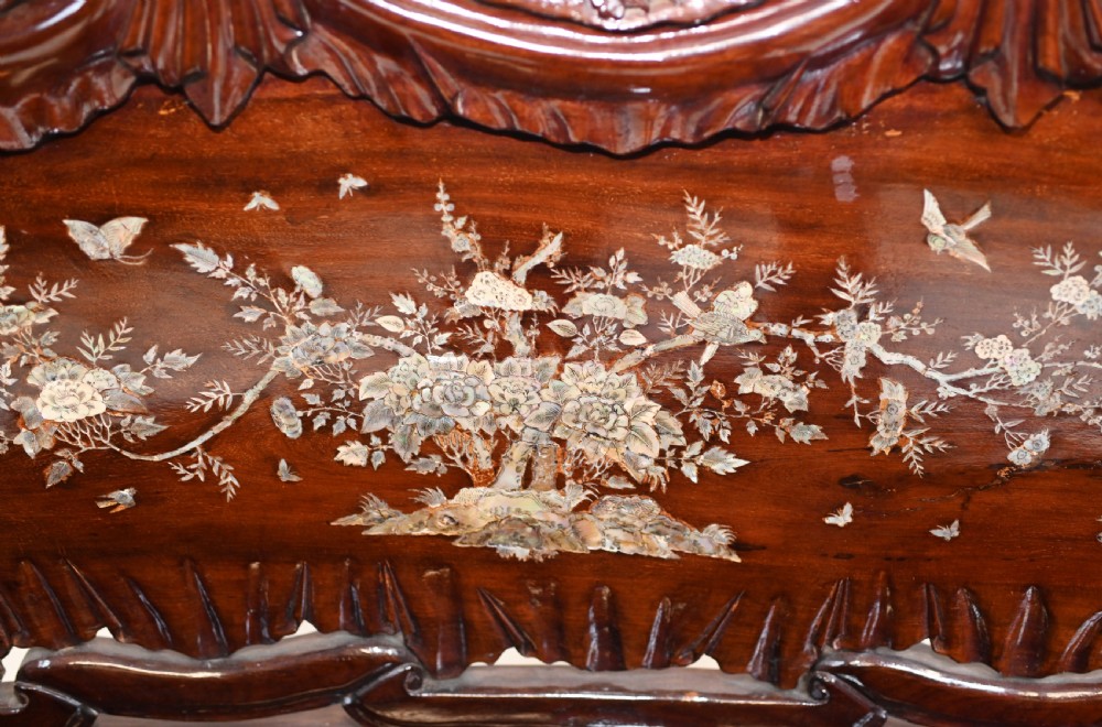A three-piece dark hardwood seating suite comprising a double bench and two armchairs, decorated with mother of pearl floral inlays and carved detailing. View IV