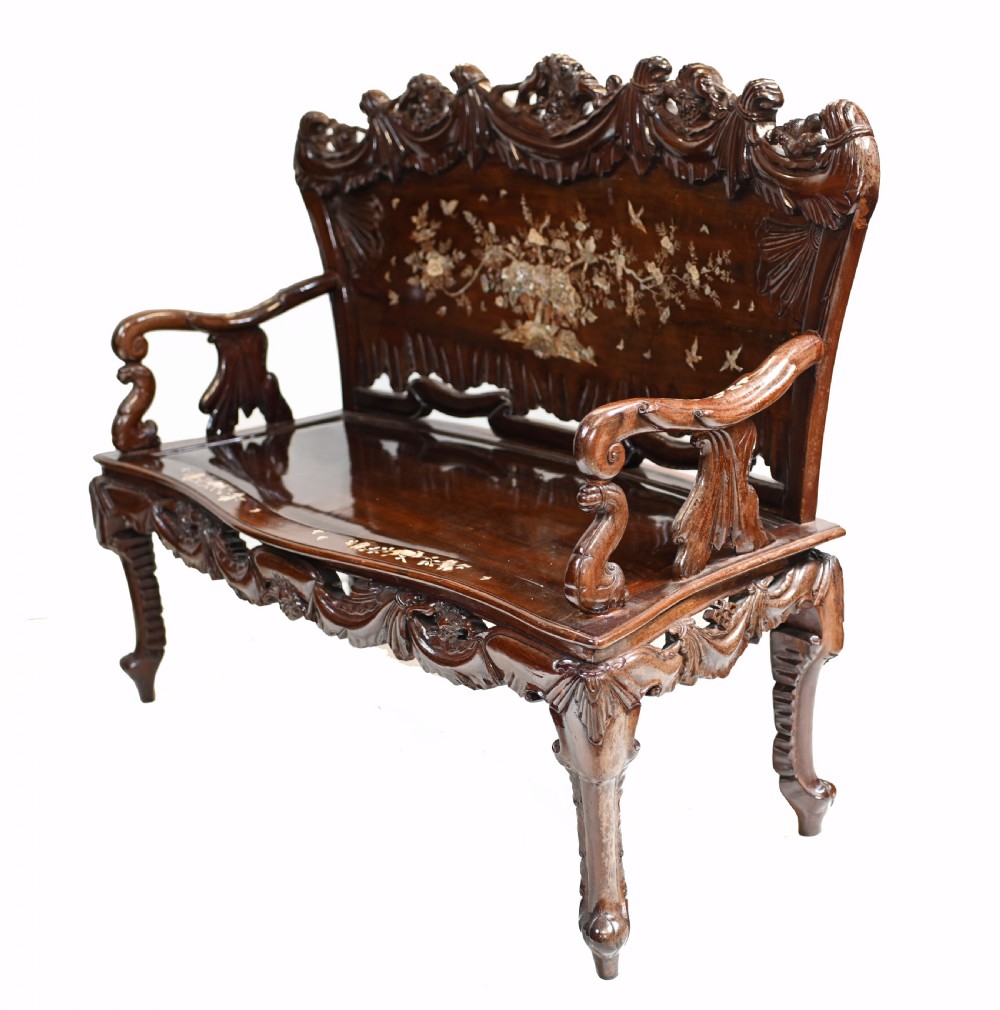 A three-piece dark hardwood seating suite comprising a double bench and two armchairs, decorated with mother of pearl floral inlays and carved detailing. View VIII