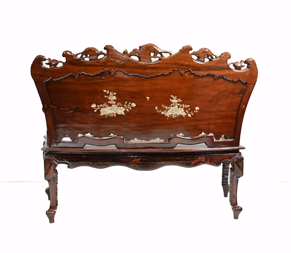 A three-piece dark hardwood seating suite comprising a double bench and two armchairs, decorated with mother of pearl floral inlays and carved detailing. View X