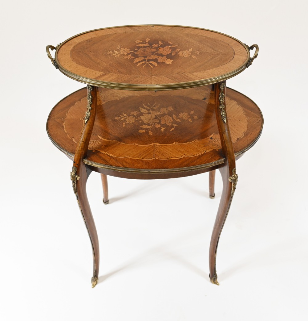 An antique French two-tiered oval etagere side table featuring floral marquetry inlay, slender cabriole legs, and polished brass mounts. View II