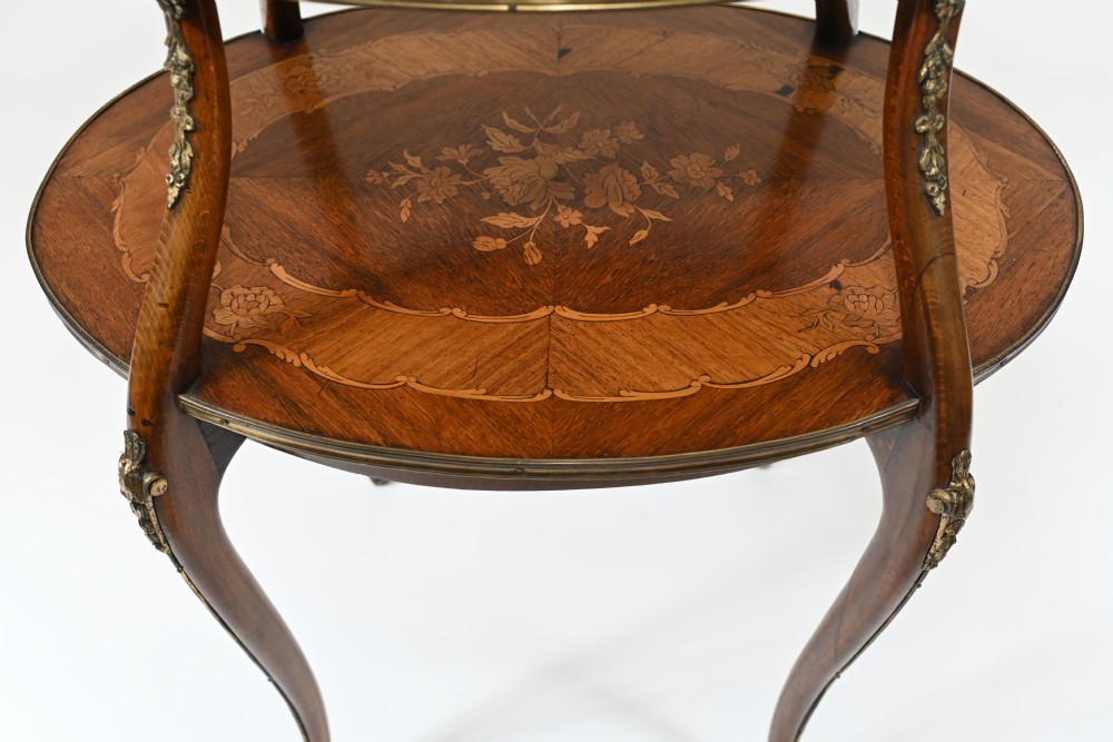 An antique French two-tiered oval etagere side table featuring floral marquetry inlay, slender cabriole legs, and polished brass mounts. View V