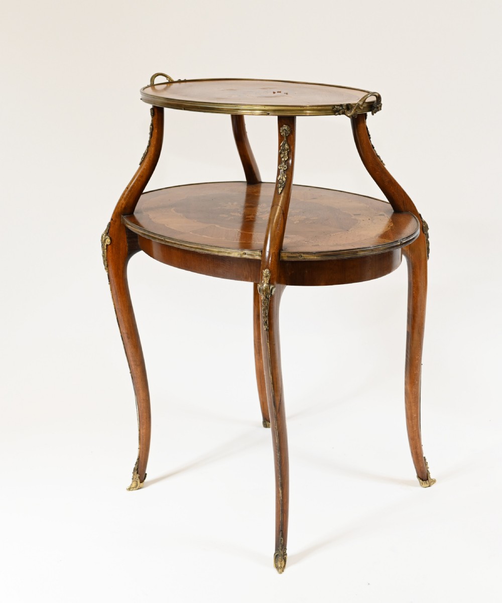 An antique French two-tiered oval etagere side table featuring floral marquetry inlay, slender cabriole legs, and polished brass mounts. View VI