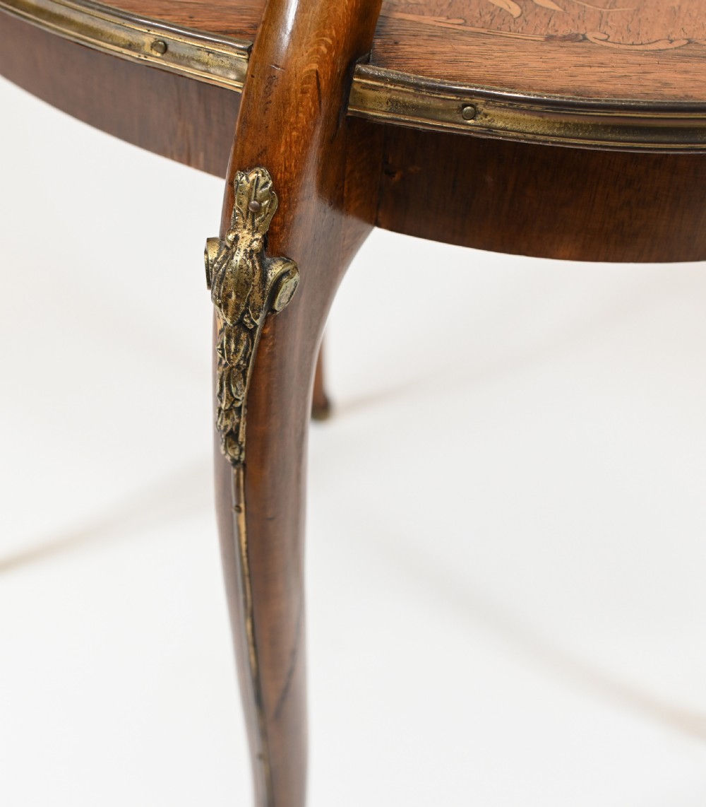 An antique French two-tiered oval etagere side table featuring floral marquetry inlay, slender cabriole legs, and polished brass mounts. View VII