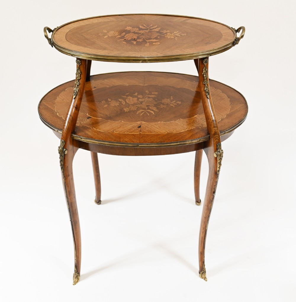 An antique French two-tiered oval etagere side table featuring floral marquetry inlay, slender cabriole legs, and polished brass mounts. View VIII