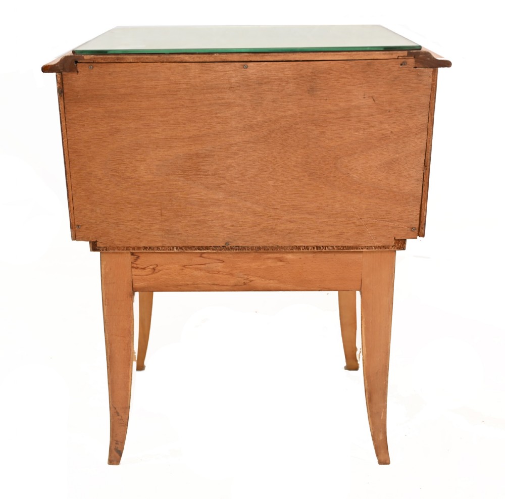 A pair of 1930s Art Deco wooden bedside cabinets featuring two drawers with diamond geometric veneers, rounded top edges with glass surface protectors, brass accents, and tapered legs. View VII