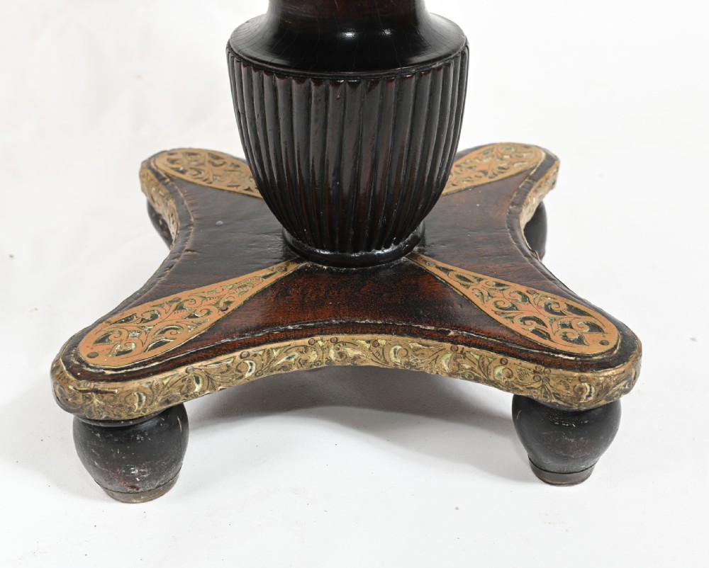 An antique dark wood Indian dowry casket decorated with intricate pierced brass straps and studs, supported on a turned central pedestal base. View VI