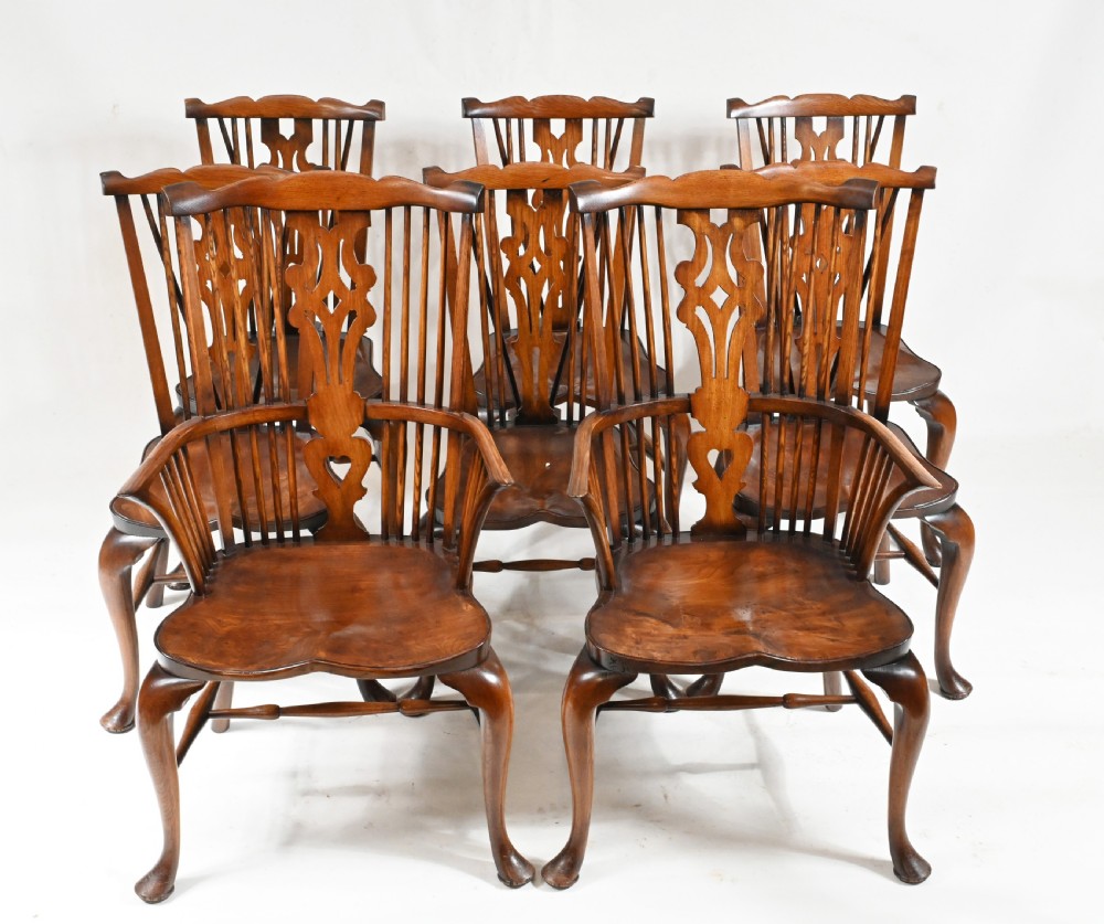 A set of eight yew wood Windsor dining chairs featuring pierced splats, saddle seats, and cabriole front legs. View II