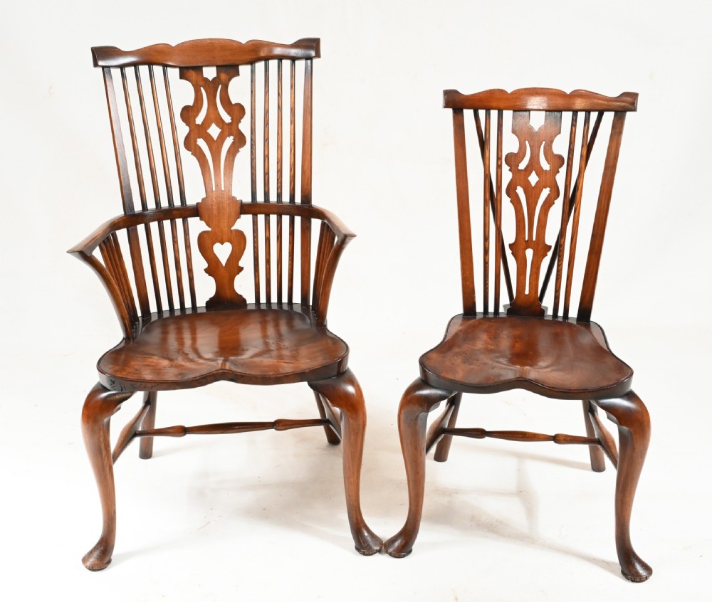 A set of eight yew wood Windsor dining chairs featuring pierced splats, saddle seats, and cabriole front legs. View III