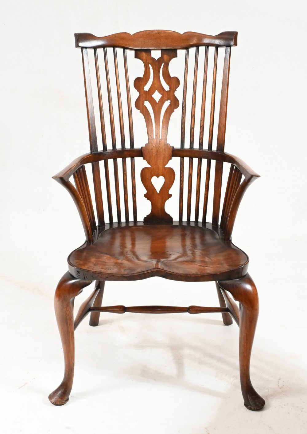 A set of eight yew wood Windsor dining chairs featuring pierced splats, saddle seats, and cabriole front legs. View V