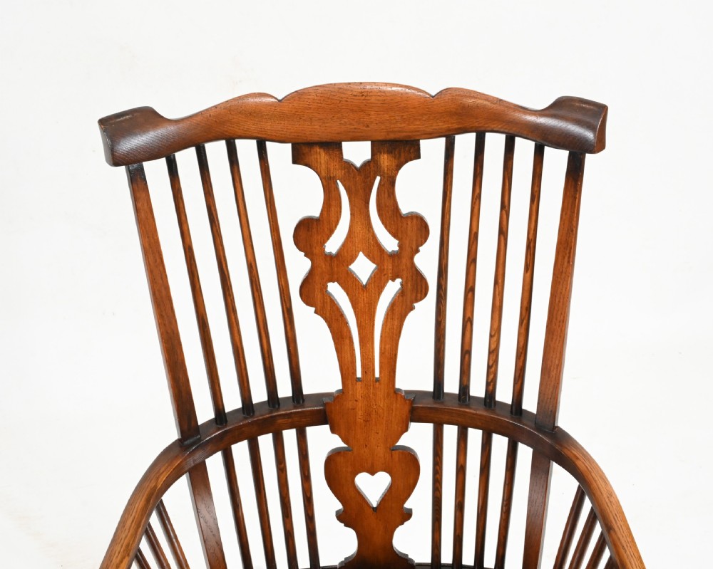 A set of eight yew wood Windsor dining chairs featuring pierced splats, saddle seats, and cabriole front legs. View VI