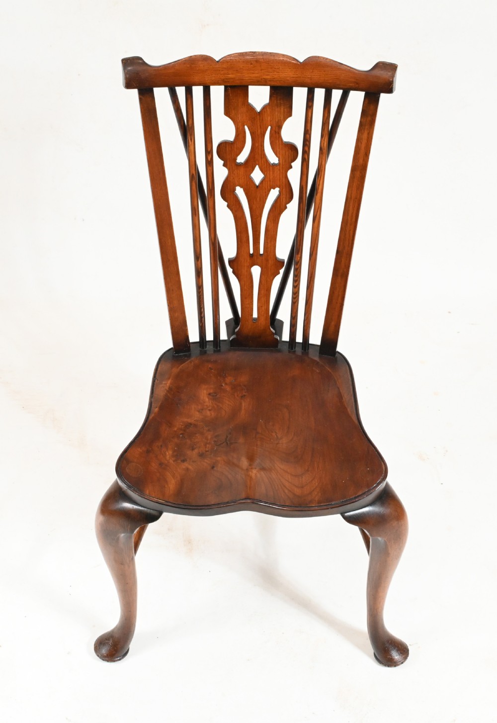A set of eight yew wood Windsor dining chairs featuring pierced splats, saddle seats, and cabriole front legs. View IX