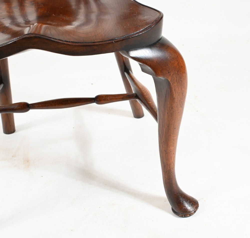 A set of eight yew wood Windsor dining chairs featuring pierced splats, saddle seats, and cabriole front legs. View X