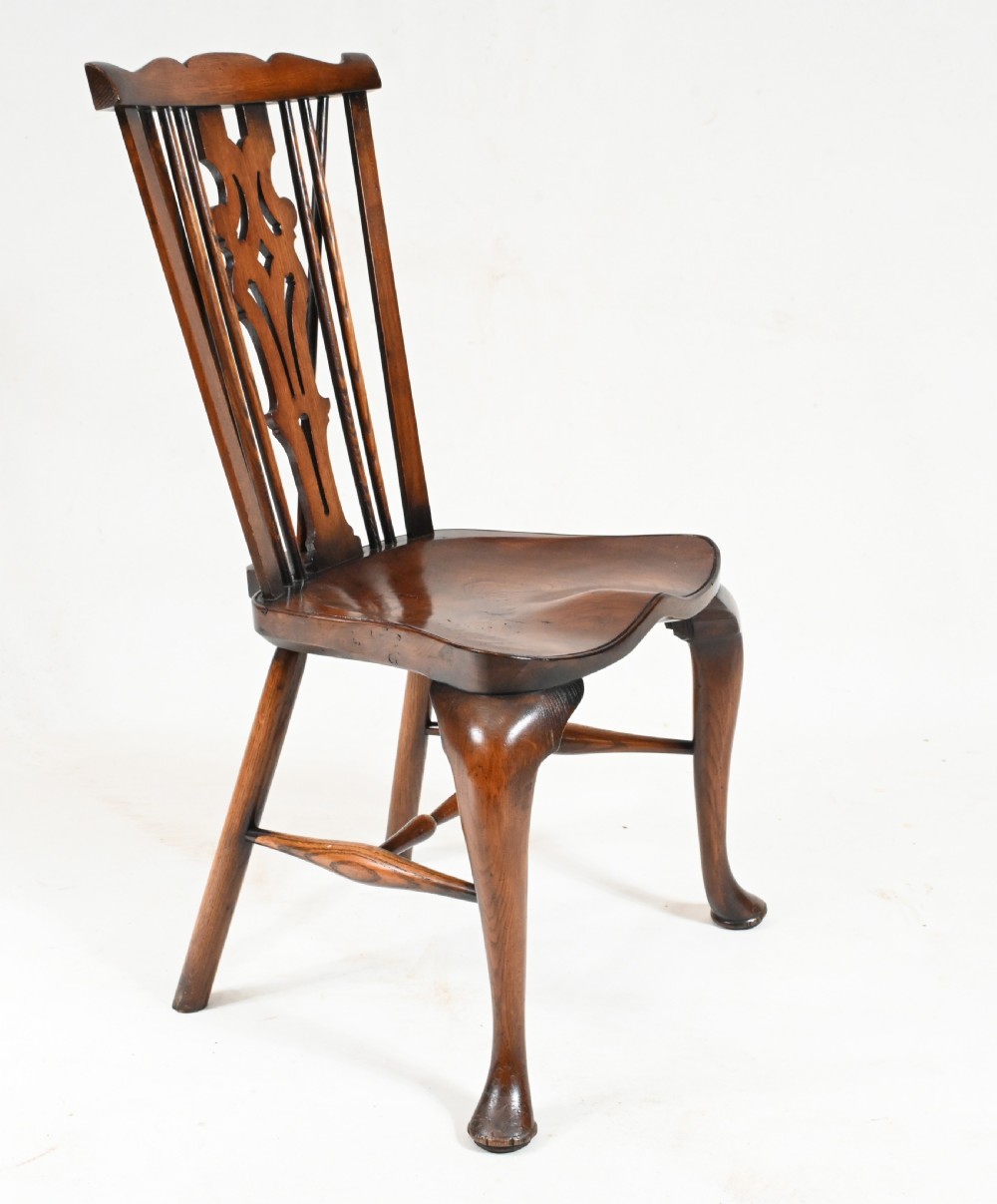 A set of eight yew wood Windsor dining chairs featuring pierced splats, saddle seats, and cabriole front legs. View XI