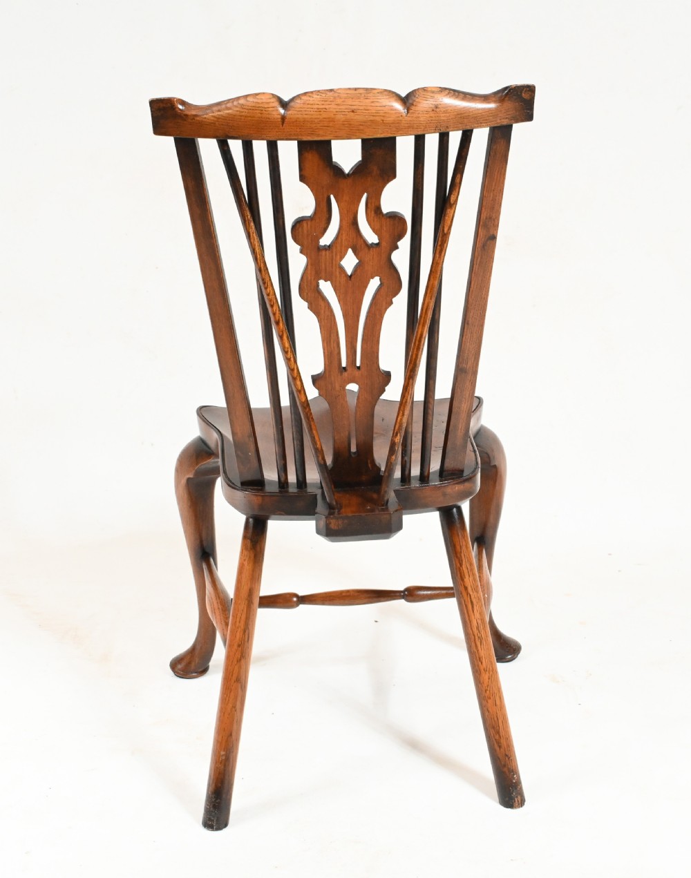 A set of eight yew wood Windsor dining chairs featuring pierced splats, saddle seats, and cabriole front legs. View XII