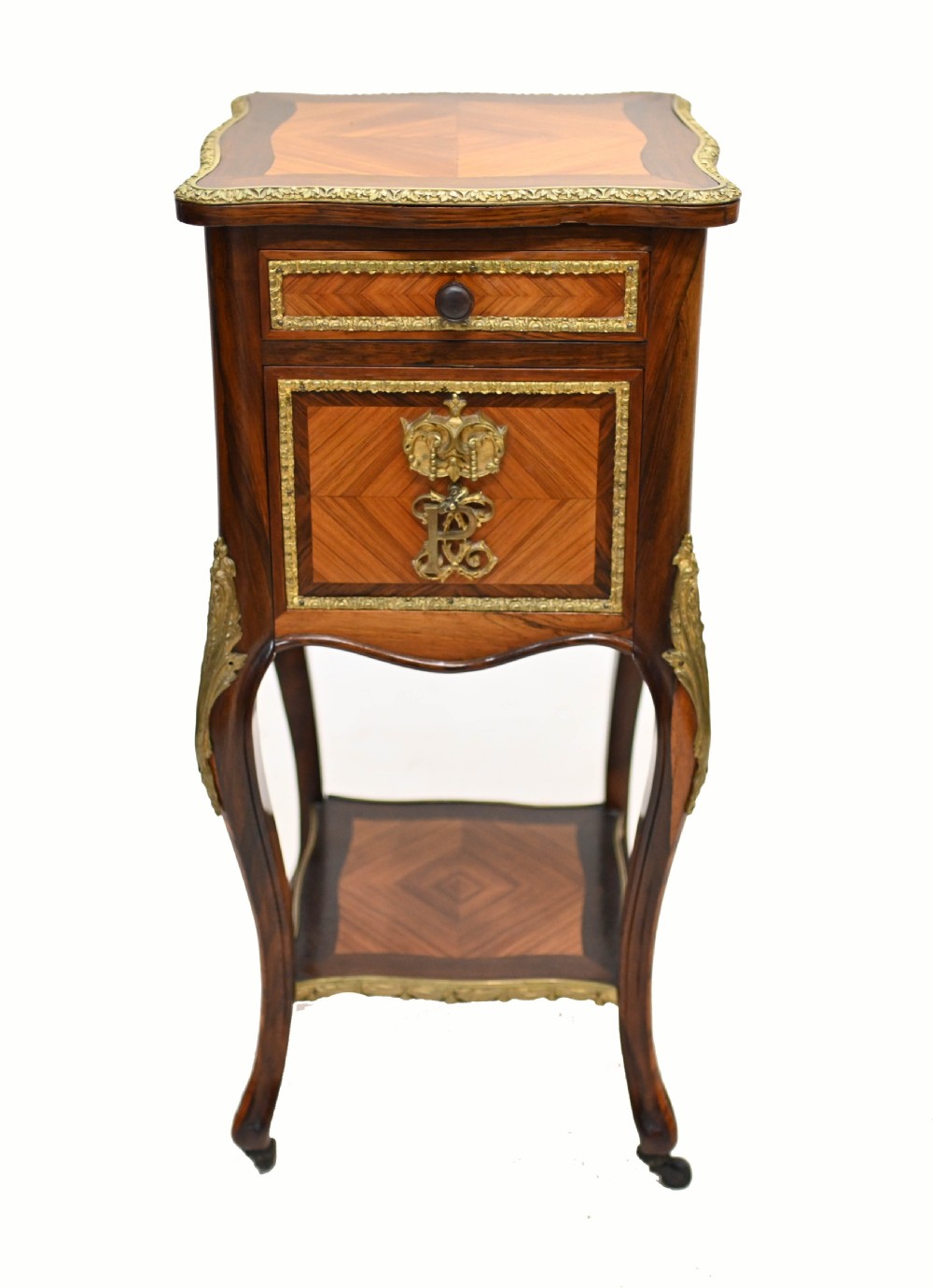 A late nineteenth-century dark mahogany occasional table featuring a circular top, pierced geometric fretwork legs, an undertier shelf, and ball feet. View III