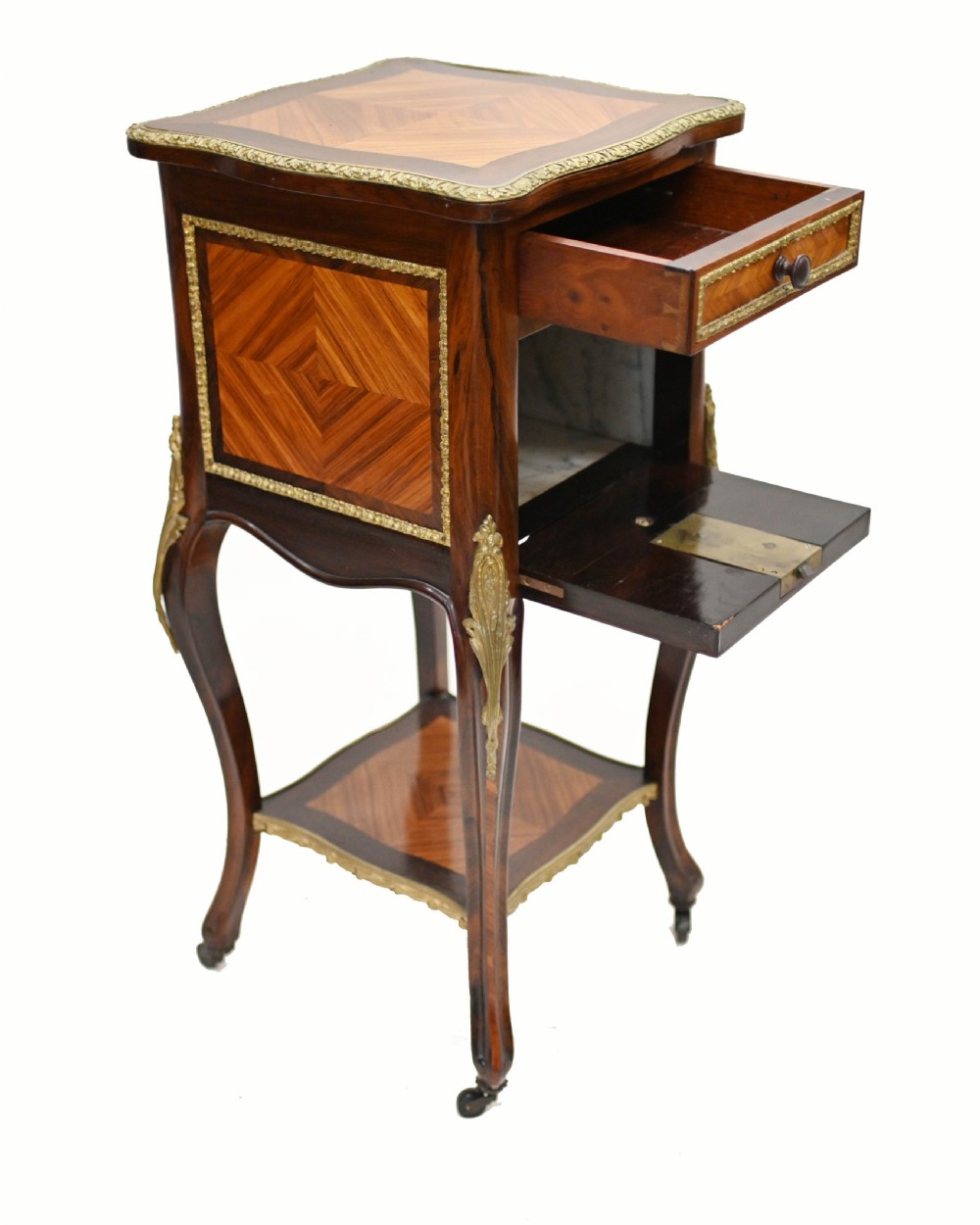 A late nineteenth-century dark mahogany occasional table featuring a circular top, pierced geometric fretwork legs, an undertier shelf, and ball feet. View V