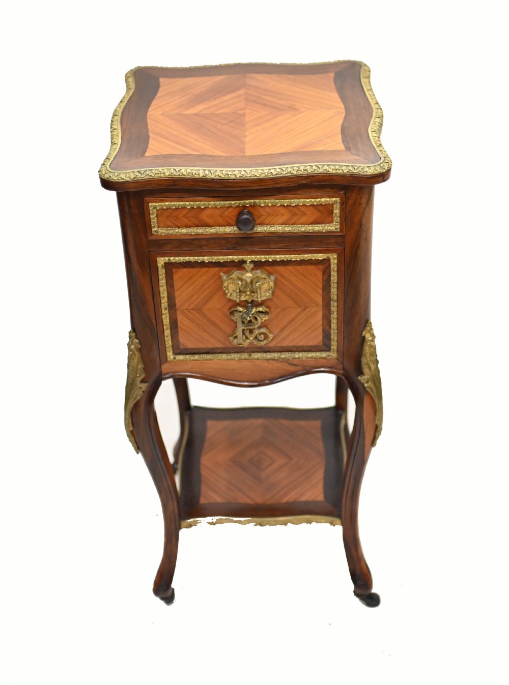 A late nineteenth-century dark mahogany occasional table featuring a circular top, pierced geometric fretwork legs, an undertier shelf, and ball feet. View VIII