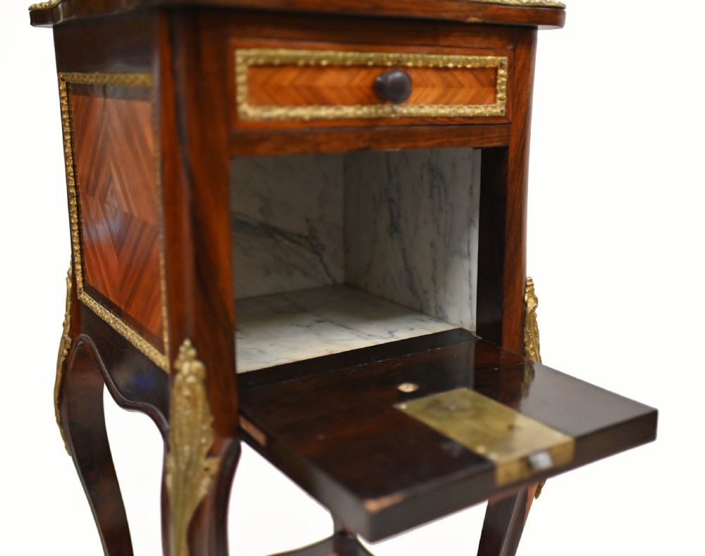 A late nineteenth-century dark mahogany occasional table featuring a circular top, pierced geometric fretwork legs, an undertier shelf, and ball feet. View X
