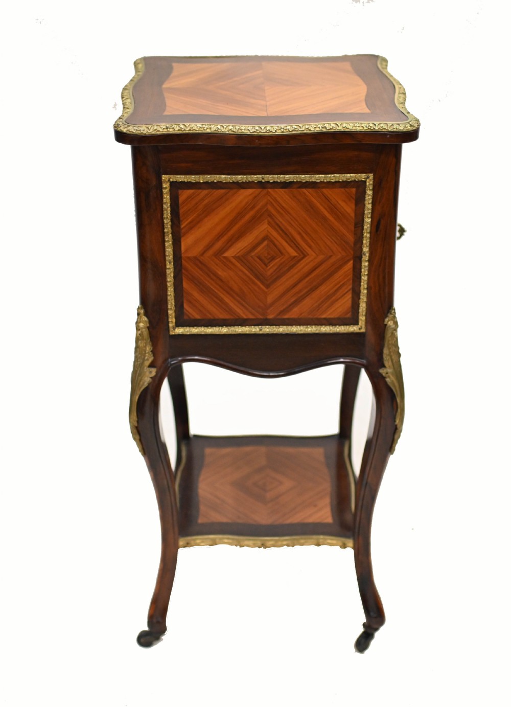 A late nineteenth-century dark mahogany occasional table featuring a circular top, pierced geometric fretwork legs, an undertier shelf, and ball feet. View XI