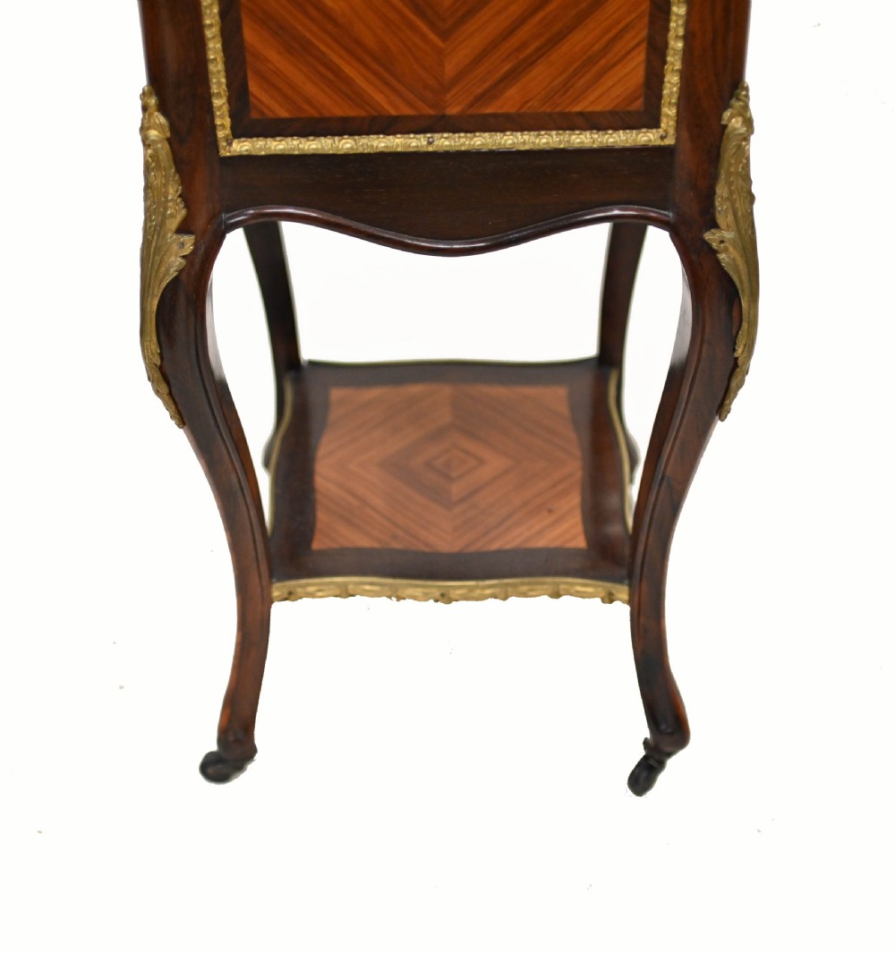 A late nineteenth-century dark mahogany occasional table featuring a circular top, pierced geometric fretwork legs, an undertier shelf, and ball feet. View XIII
