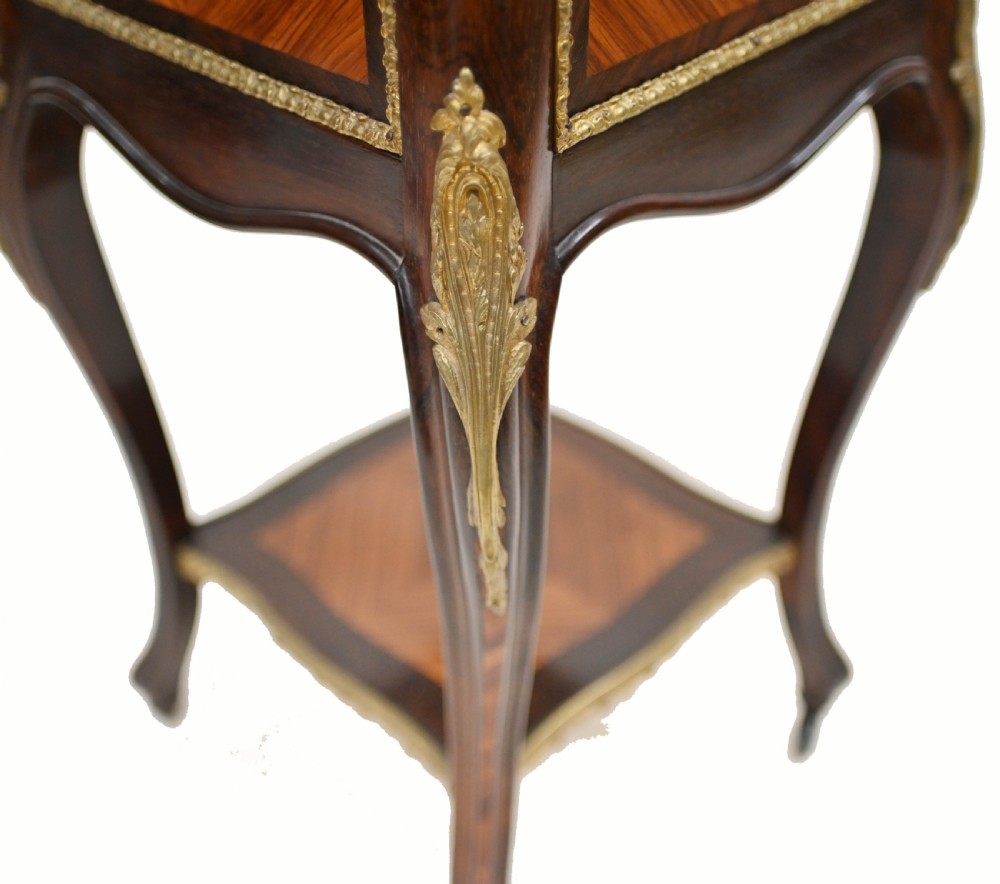 A late nineteenth-century dark mahogany occasional table featuring a circular top, pierced geometric fretwork legs, an undertier shelf, and ball feet. View XVI