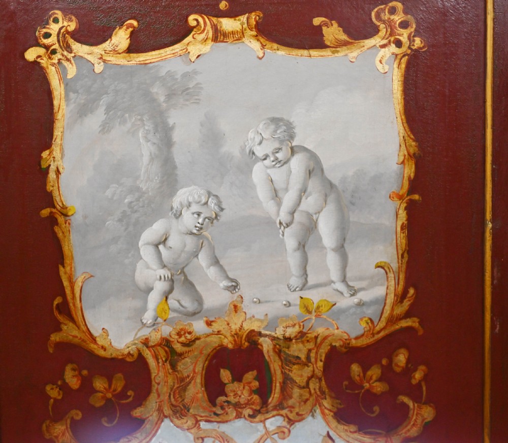 A red six-panel folding screen painted with classical figures, cherubs, and urns within gilded scrollwork borders. View IV