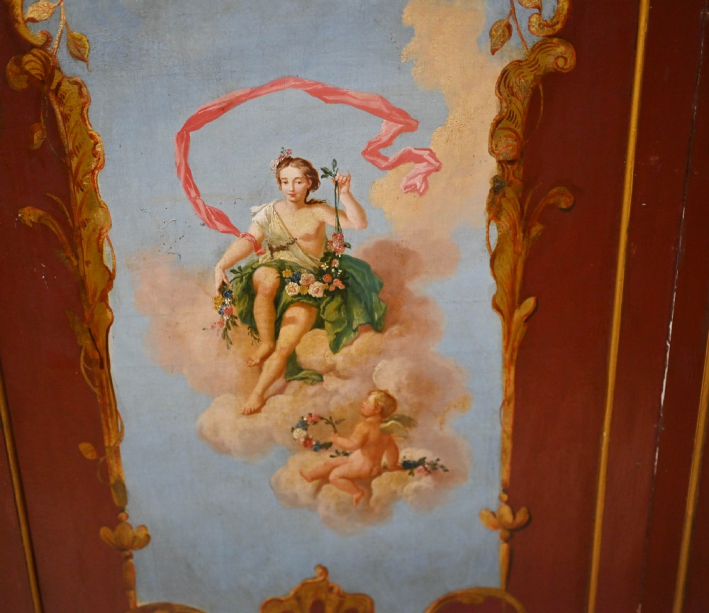 A red six-panel folding screen painted with classical figures, cherubs, and urns within gilded scrollwork borders. View VII