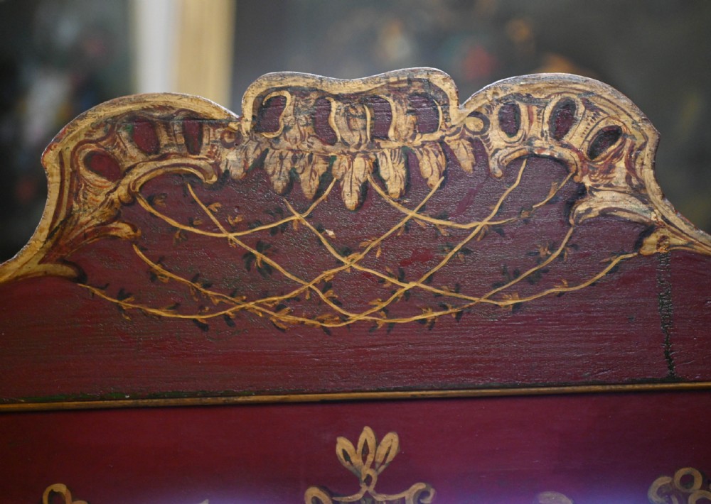 A red six-panel folding screen painted with classical figures, cherubs, and urns within gilded scrollwork borders. View XV