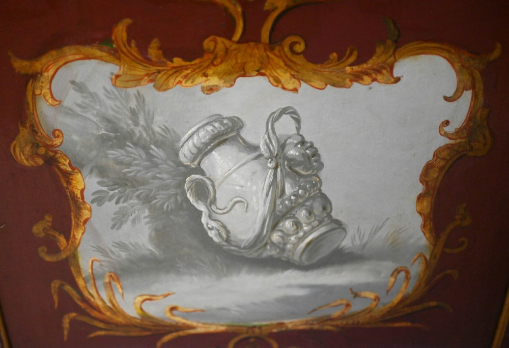 A red six-panel folding screen painted with classical figures, cherubs, and urns within gilded scrollwork borders. View XVI