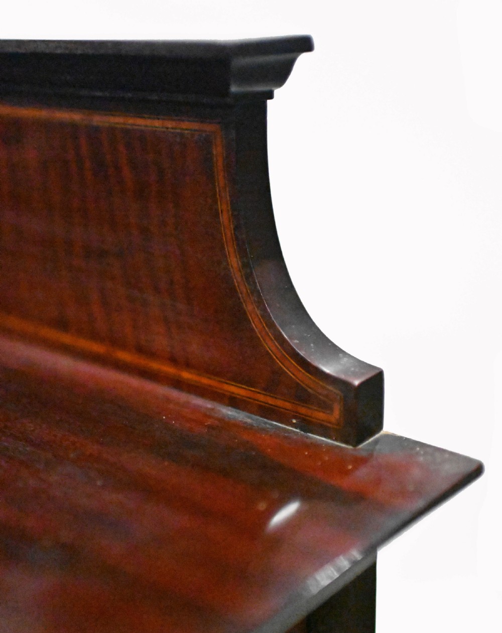 An Edwardian mahogany display cabinet featuring astragal glazed doors flanking a central inlaid cupboard door raised on square tapered legs. View XI