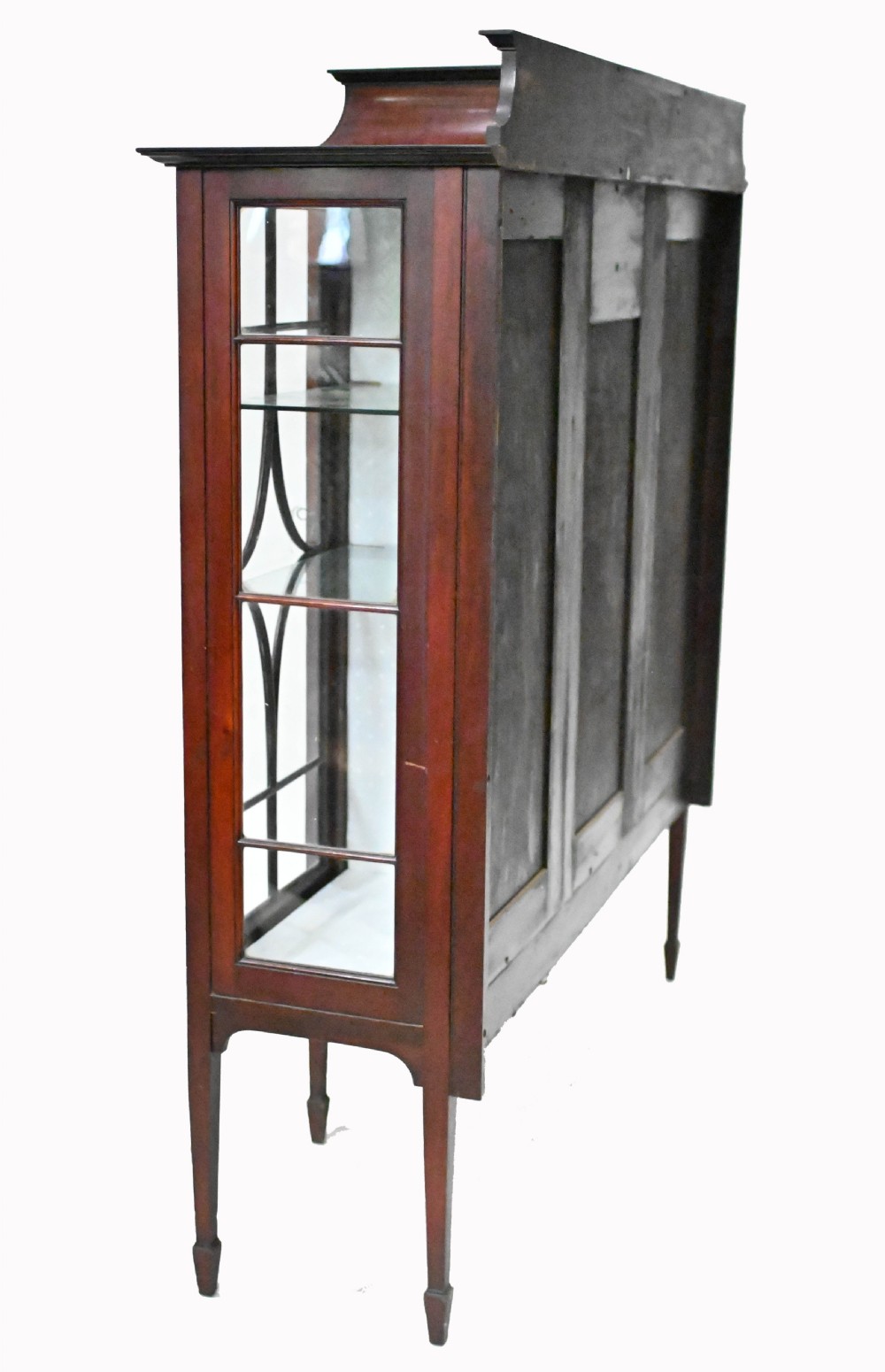 An Edwardian mahogany display cabinet featuring astragal glazed doors flanking a central inlaid cupboard door raised on square tapered legs. View XII