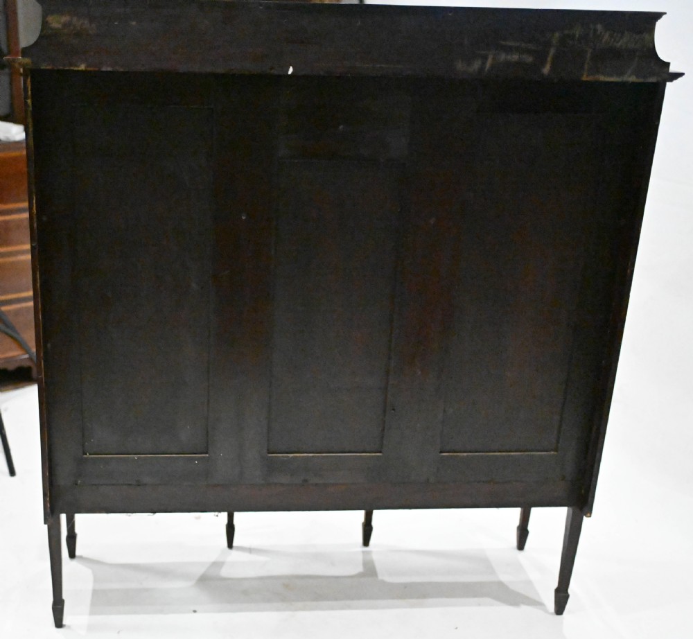 An Edwardian mahogany display cabinet featuring astragal glazed doors flanking a central inlaid cupboard door raised on square tapered legs. View XIII