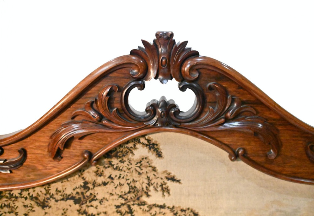 An early Victorian carved wooden fire screen featuring a hand-worked needlepoint tapestry of a pastoral scene set within a scrolled frame. View II